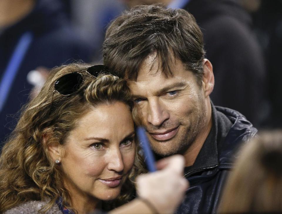 Harry Connick, Jr., right, poses for a picture with his wife, Jill Goodacre, before the NFL Super Bowl XLVIII football game Sunday, Feb. 2, 2014, in East Rutherford, N.J. (AP Photo/Kathy Willens)
