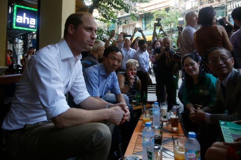 Britain's Prince William chats with Vietnamese residents at a cafe in the old quarters of Hanoi on November 16, 2016