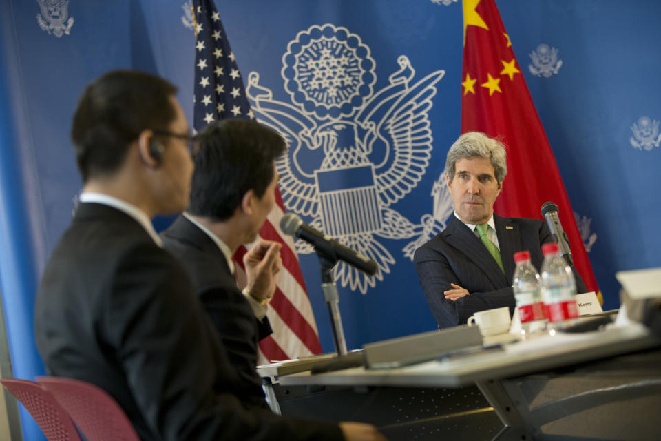 U.S. Secretary of State John Kerry, right, listens to a question during a discussion with Chinese bloggers on a number of issues, including internet freedom, Chinese territorial disputes with Japan, North Korea, and human rights, on Saturday, Feb. 15, 2014, in Beijing, China. (AP Photo/Evan Vucci, Pool)