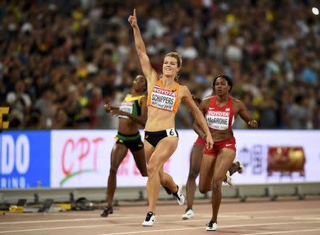 Dafne Schippers of Netherlands (C) celebrates as she crosses the finish line to win the women's 200 metres final during the 15th IAAF World Championships at the National Stadium in Beijing, China August 28, 2015. REUTERS/Dylan Martinez