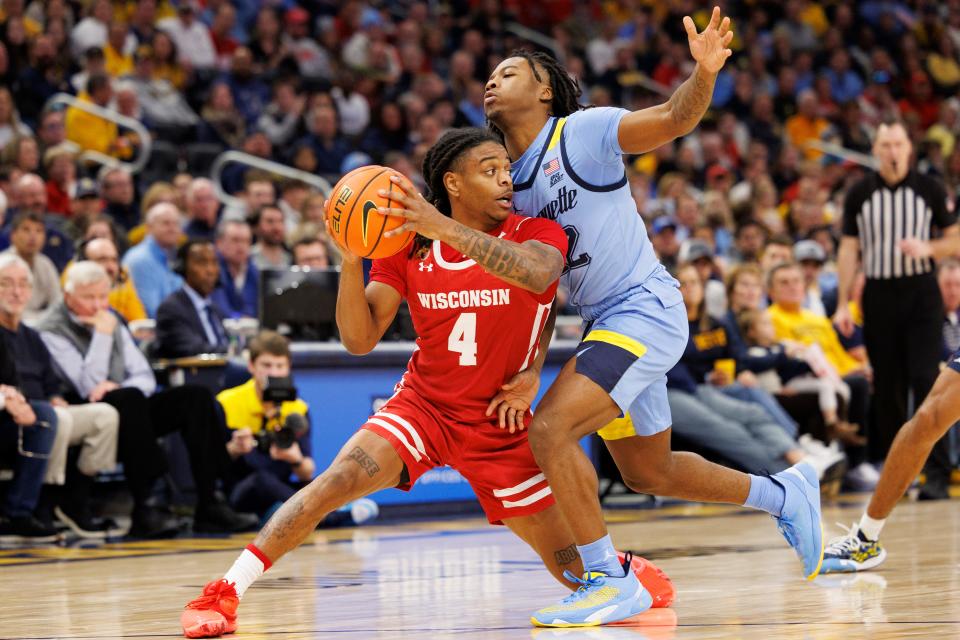 Wisconsin guard Kamari McGee battles Marquette's Sean Jones during last season's game.