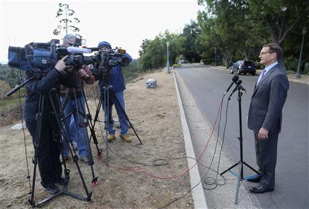 Jeffrey Newman comes out of his home to make a brief comment about his father, Merrill Newman, an 85-year-old Korean War veteran being detained by North Korean authorities, in Pasadena, California November 22, 2013. REUTERS/Jonathan Alcorn