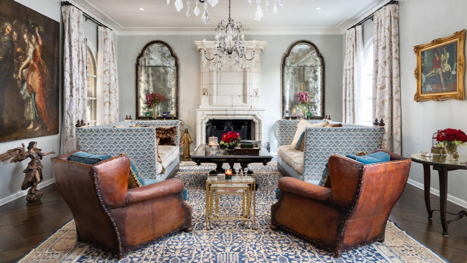 The home’s living room is capped by an ornate chandelier.