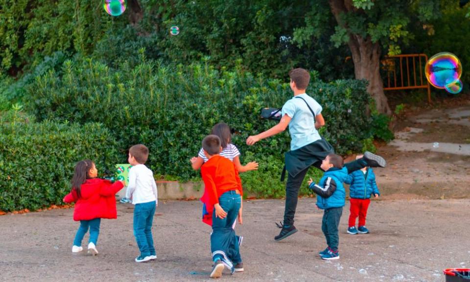 Children play with bubbles in Barcelona, Spain.