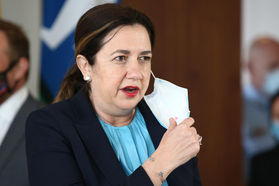 Queensland Premier Annastacia Palaszczuk takes off her face mask to speak during a press conference on June 29, 2021 in Brisbane, Australia