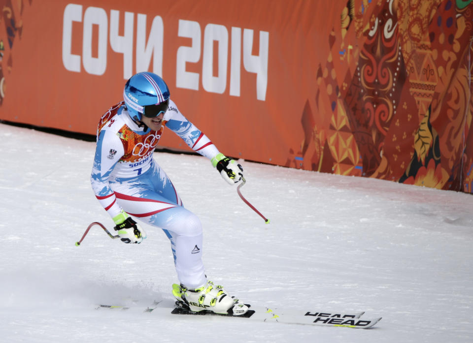 Austria's Matthias Mayer finishes to win the gold in the men's downhill at the Sochi 2014 Winter Olympics, Sunday, Feb. 9, 2014, in Krasnaya Polyana, Russia. (AP Photo/Gero Breloer)