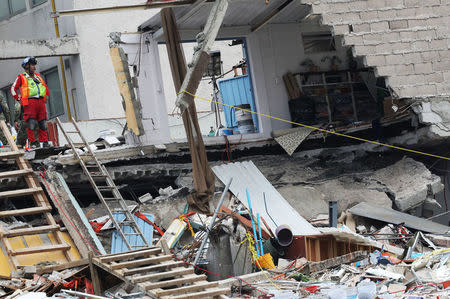 A member of rescue team looks on, in the rubble of a collapsed building, after an earthquake in Mexico City, Mexico September 25, 2017. REUTERS/Nacho Doce