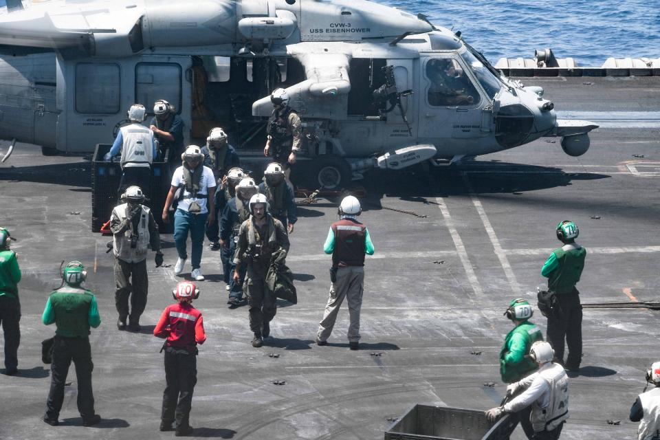 Sailors from the Dwight D. Eisenhower Carrier Strike Group assist distressed mariners rescued from the M/V Tutor on June 15, 2024.