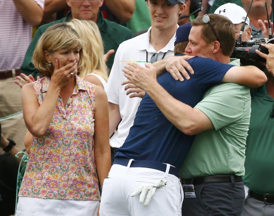 Jordan Spieth of the U.S. hugs his father Shawn as his mother Chris looks on after winning the Masters golf tournament at the Augusta National Golf Course in Augusta, Georgia April 12, 2015. REUTERS/Mark Blinch