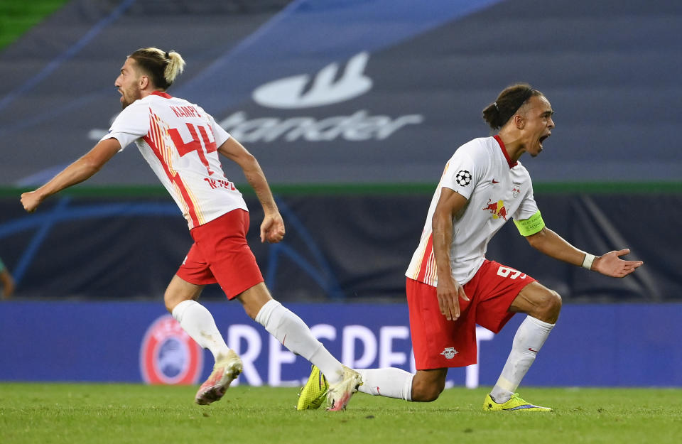 Leipzig's Yussuf Poulsen, right, and teammate Kevin Kampl celebrate after their team's Champions League quarterfinal win over Atletico Madrid at the Jose Alvalade stadium in Lisbon, Portugal, Thursday, Aug. 13, 2020. (Lluis Gene/Pool Photo via AP)