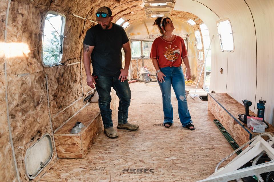 Sasha and Craig Poole look over the interior of an 1973 Airstream as they renovate the trailer into a new business adventure, the Sunshine Gypsy Boutique, in Warren Township.