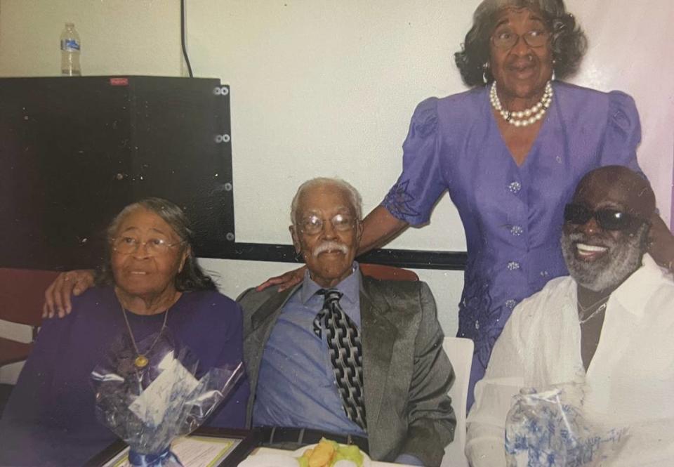 Nancy Dawkins (left) seated next to her husband Miller Dawkins (second from left) and family friend T. Willard Fair (right).