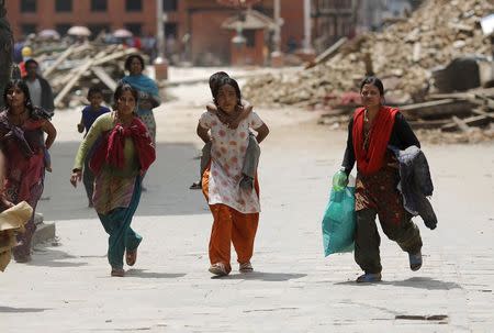 People rush for safety during a strong aftershock after an earthquake, in Kathmandu, Nepal April 26, 2015. REUTERS/Adnan Abidi