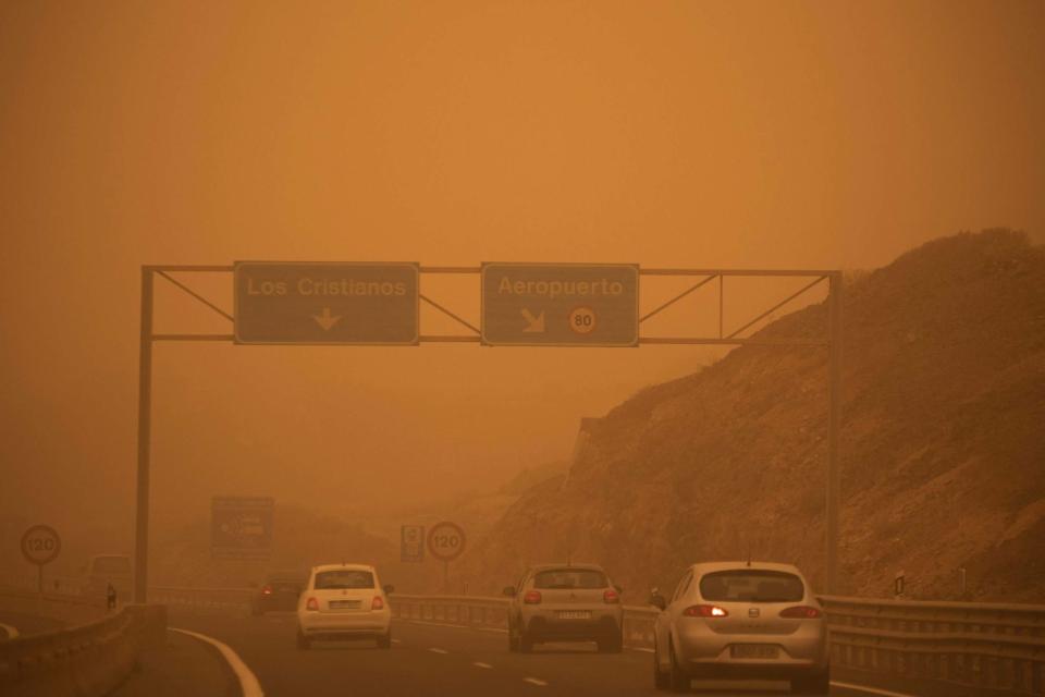 Cars drive on the TF-1 highway during a sandstorm in Santa Cruz de Tenerife (AFP via Getty Images)