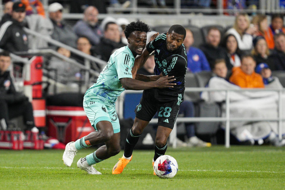 Portland Timbers midfielder Santiago Moreno, left, battles with FC Cincinnati defender Ray Gaddis (28) during the second half of an MLS soccer match Saturday, April 22, 2023, in Cincinnati. (AP Photo/Jeff Dean)