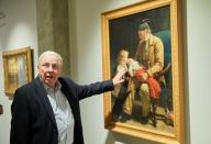 Swiss billionaire and politician Blocher alks about the painting "Veillard et deux enfants" by Albert Anker during a guided visit in Martigny