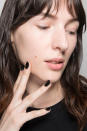 <p>The runway collection was inspired by the vintage “cool girl” with an undone look, and the nails were inspired by latex tights. So manicurist Geraldine Holford created a black matte manicure with a porcelain white stripe using Dermelect custom blend polish in True Black and Opulence. (Photo: Imaxtree) </p>