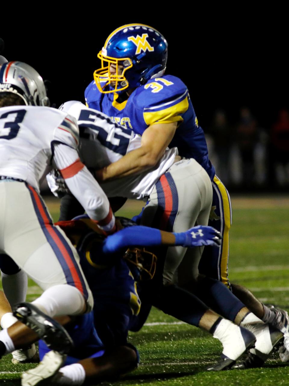 Ty Shawger, of West Muskingum, makes a tackle on Morgan's Carson Copeland on Friday night in Falls Townshiip.