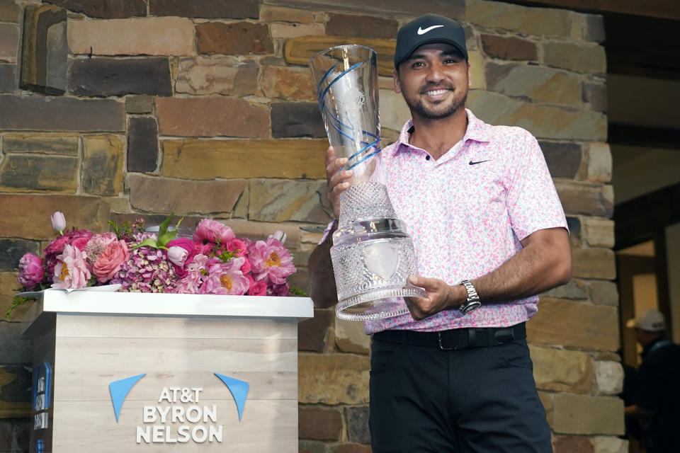 Jason Day, of Australia, poses for photos with the trophy after winning the Byron Nelson golf tournament in McKinney, Texas, Sunday, May 14, 2023. (AP Photo/LM Otero)