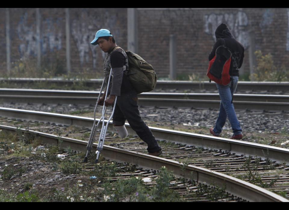 In this May 12, 2012 photo, a Central American migrant, who lost a leg when he fell from a train, walks on crutches along the tracks while waiting for a train to continue his journey to the US-Mexico border, in Lecheria, on the outskirts of Mexico City. While the number of Mexicans heading to the U.S. has dropped dramatically, a surge of Central American migrants is making the 1,000-mile northbound journey this year, fueled in large part by the rising violence brought by the spread of Mexican drug cartels. (AP Photo/Marco Ugarte)