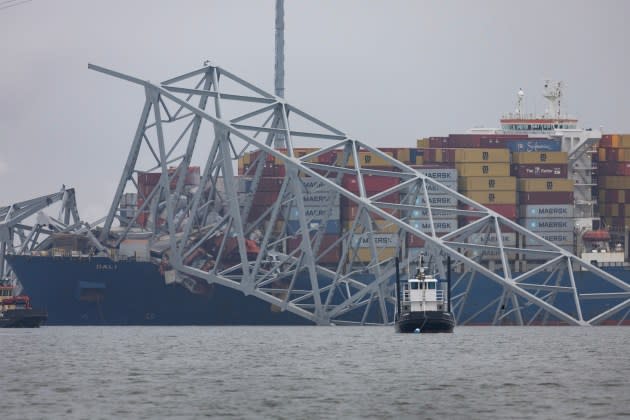 Workers continue to investigate and search for victims after the cargo ship Dali collided yesterday with the Francis Scott Key Bridge, on March 27, 2024 in Baltimore, Maryland.  - Credit: Scott Olson/Getty Images