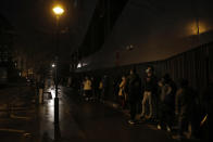 Students line up for free food aid organized by Linkee, a Paris-based company collecting food waste, in Paris, Thursday, Feb. 4, 2021. The pandemic has devastated economies the world over. In France, the economic fallout has weighed particularly heavily on young people — and their woes have only been compounded by disruptions to their studies and social interactions. (AP Photo/Christophe Ena)