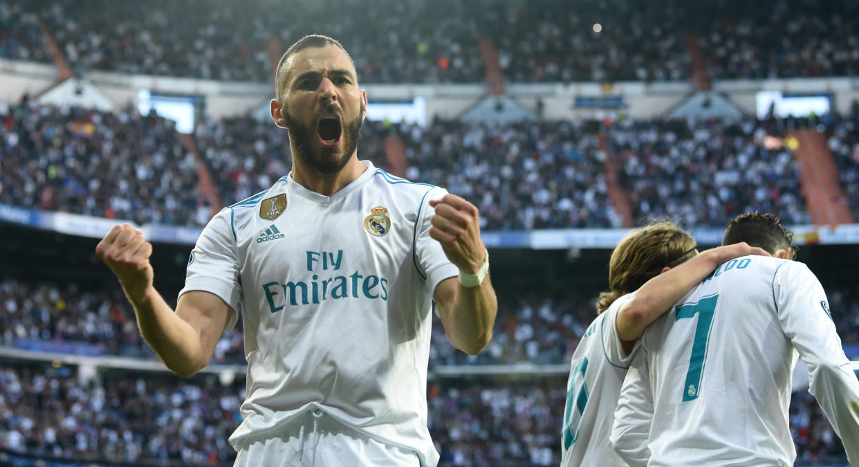 TOPSHOT - Real Madrid's French forward Karim Benzema (L) celebrates scoring next to Real Madrid's Croatian midfielder Luka Modric (2R) and Real Madrid's Portuguese forward Cristiano Ronaldo  during the UEFA Champions League semi-final second-leg football match Real Madrid CF vs FC Bayern Munich in Madrid, Spain, on May 1, 2018. (Photo by Christof STACHE / AFP)        (Photo credit should read CHRISTOF STACHE/AFP via Getty Images)