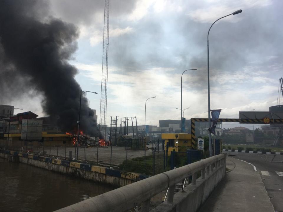 A general view of a building on fire near the Lekki-Ikoyi Toll Gate in Lagos on Oct. 21, 2020, after a deadly shooting of peaceful protesters in Lagos that Amnesty International blamed on security forces.<span class="copyright">Sophie Bouillon—AFP/Getty Images</span>