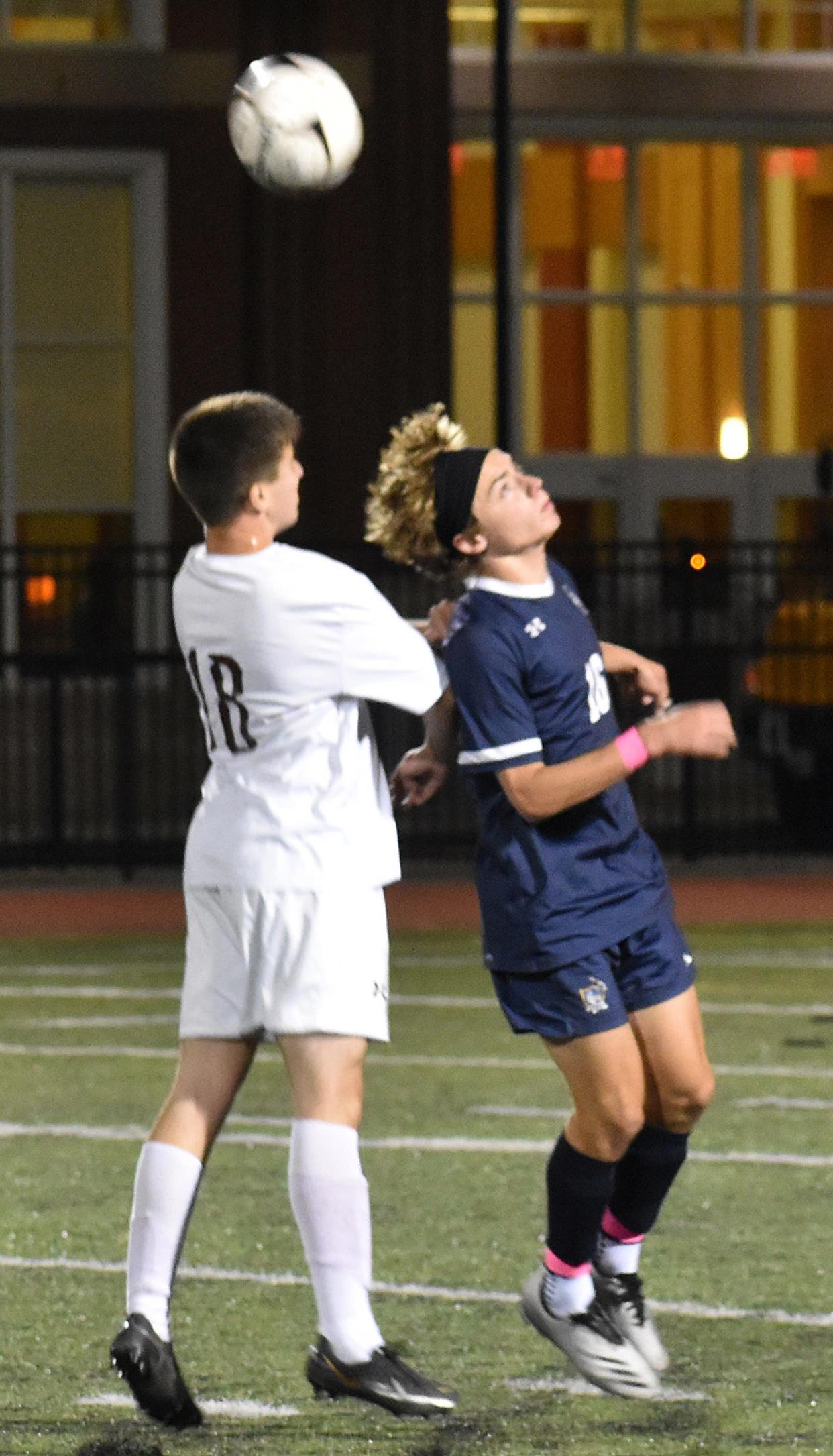 Case's Logan Prazeres, left, and Somerset Berkley's Nicolas Scanlon reach for the ball during their soccer game on Wednesday.