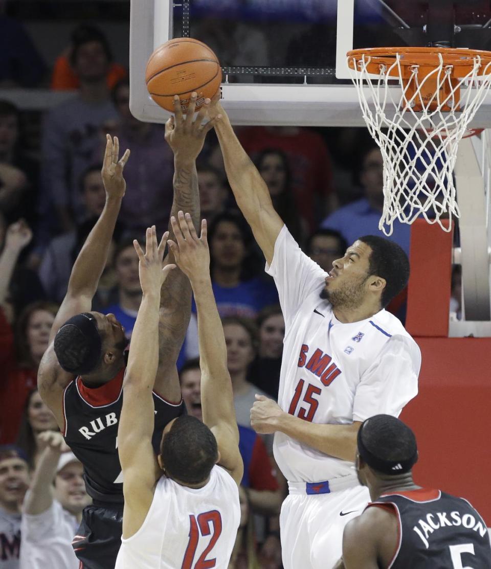 SMU center Cannen Cunningham (15) blocks a shot by Cincinnati forward Titus Rubles (2) during the first half of an NCAA college basketball game Saturday, Feb. 8, 2014, in Dallas. (AP Photo/LM Otero)