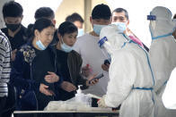 People register for COVID-19 tests at a coronavirus testing facility in Beijing, Saturday, April 23, 2022. Beijing is on alert after 10 middle school students tested positive for COVID-19 on Friday, in what city officials said was an initial round of testing. (AP Photo/Mark Schiefelbein)