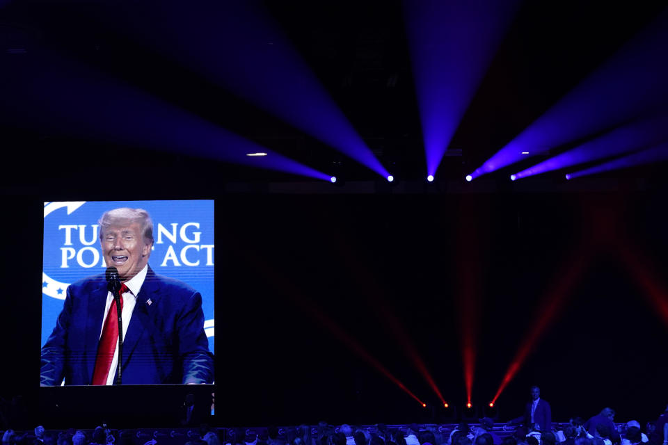 Former President Donald Trump is projected onto a screen as he speaks at the Turning Point Action conference, Saturday, July 15, 2023, in West Palm Beach, Fla. (AP Photo/Lynne Sladky)