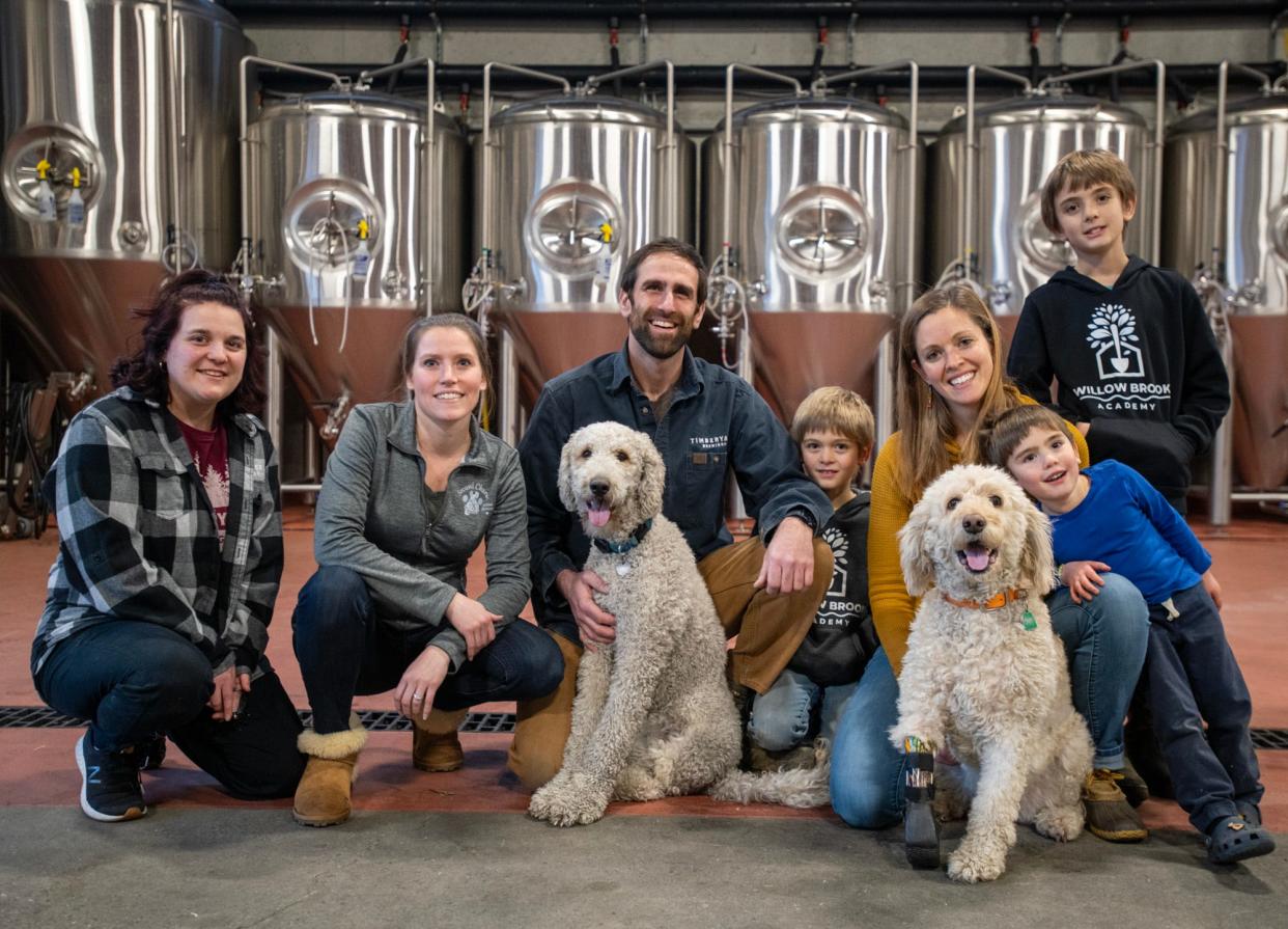 From left, bar server Alyssa Fahey, Lindsay Doray of Second Chance Animal Services, Matthew Zarif with Nugget, 8-year-old Flint, Nellie Zarif with Lucy, 3-year-old Wade, and 10-year-old Everett at Timberyard Brewing Co. in East Brookfield.