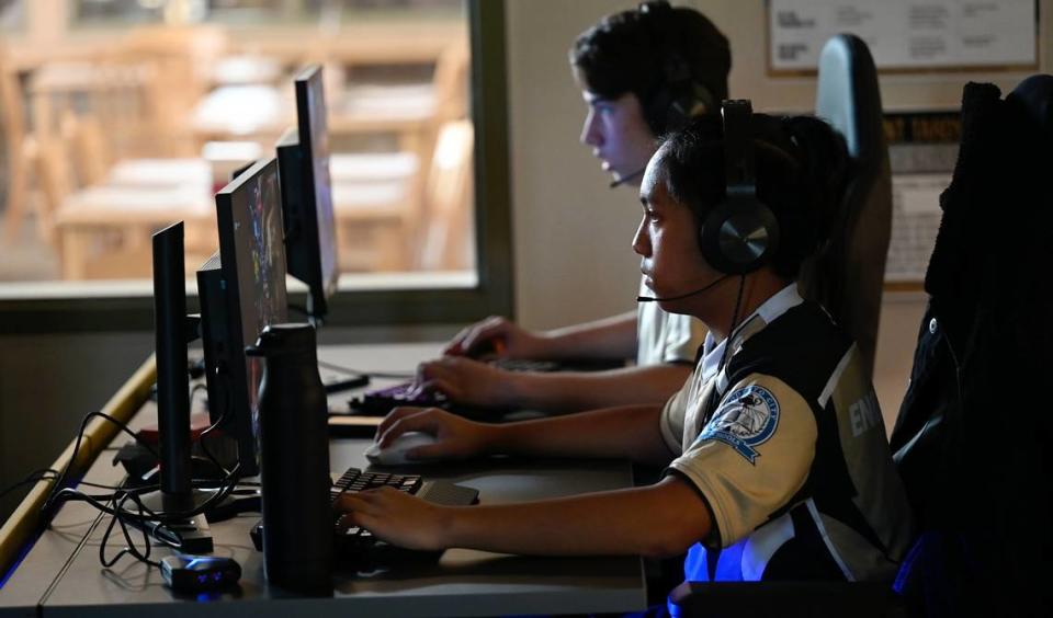 Enochs esport players Vince Alincastre, right, and Parker Carnahan warm up before an Overwatch match against Tracy High School at Enochs High School in Modesto, Calif., Tuesday, Sept. 19, 2023.