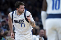 Dallas Mavericks guard Luka Doncic (77) reacts after making a shot during the first half of an NBA basketball game against the Charlotte Hornets Tuesday, April 9, 2024, in Charlotte, N.C. (AP Photo/Jacob Kupferman)