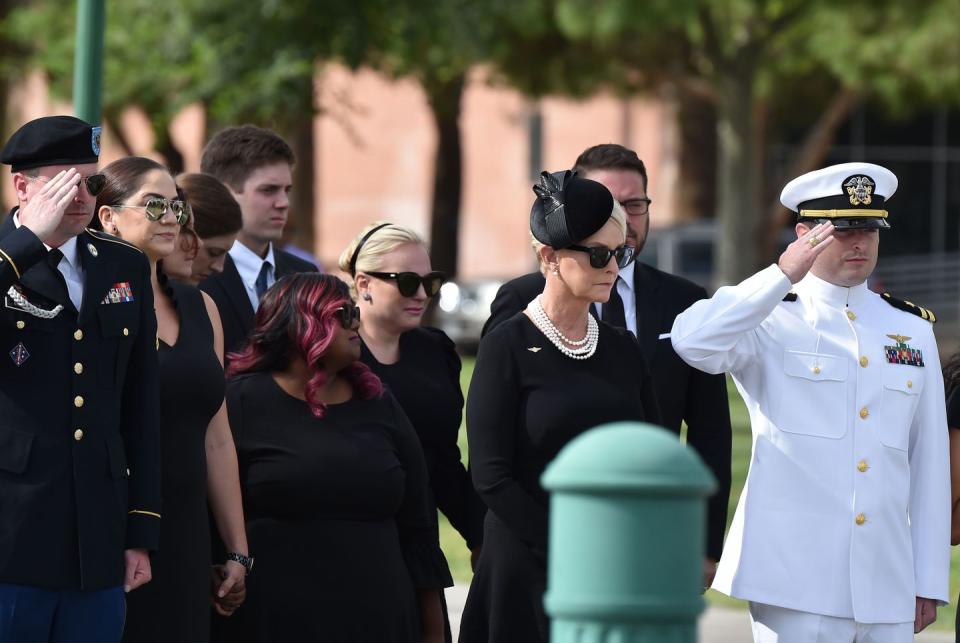 32) Jimmy, Bridget, Meghan, and Jack McCain stand with their mother, Cindy, at the memorial.
