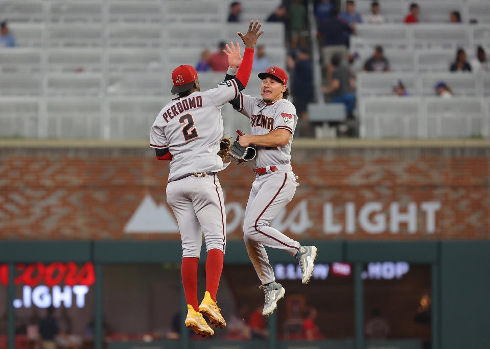 Alek Thomas, right, and Geraldo Perdomo celebrate a dramatic Arizona win. (Kevin C. Cox/Getty Images)