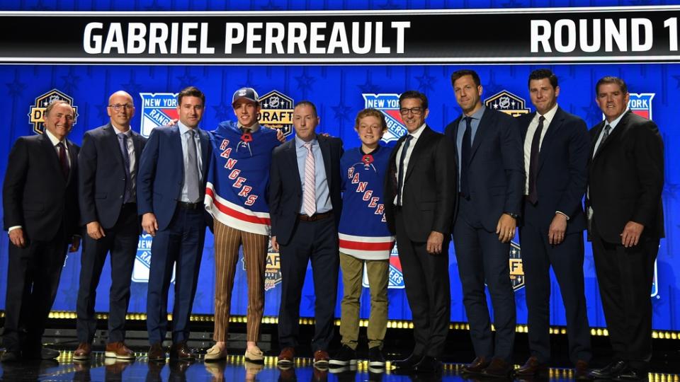 New York Rangers draft pick Gabriel Perreault stands with Rangers staff after being selected with the twenty third pick in round one of the 2023 NHL Draft at Bridgestone Arena