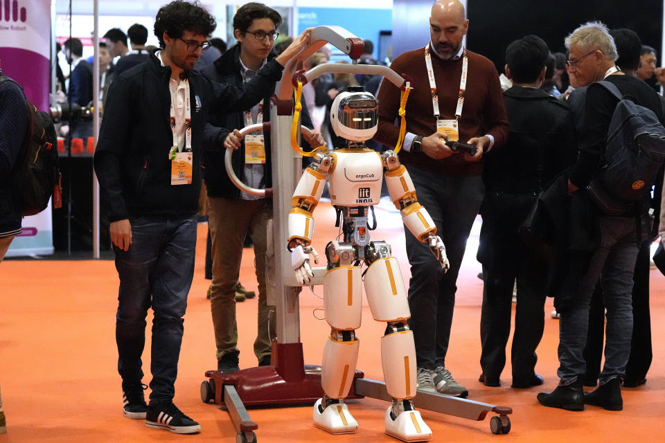 A robot from the Italian IIT interacts with visitors during the International Conference on Robotics and Automation ICRA in London, Tuesday, May 30, 2023. The 2023 ICRA brings together the world's top academics, researchers, and industry representatives to show the newest developments. (AP Photo/Frank Augstein)