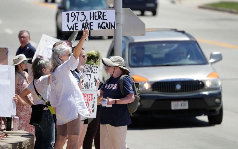 A sign claims we are back in 1973 again during the Rally for Reproductive Freedom at 14th and Erie Avenue, Sunday, June 26, 2022, in Sheboygan, Wis.  The rally, sponsored by the Sheboygan Abortion Rights Coalition, is a response to the United States Supreme Court decision which reversed Roe v. Wade this past Friday.