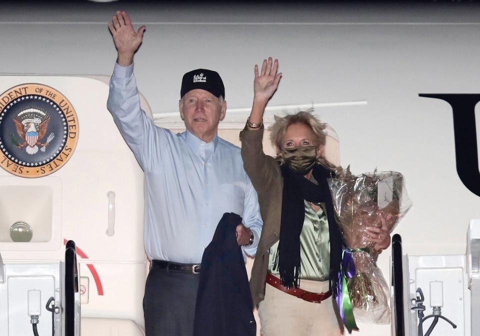 President Joe Biden and first lady Jill Biden wave from the stairs of Air Force One at Andrews Air Force Base