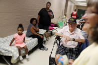 Korea war veteran, Ed Coddington, 83, second from right, and wife Esther, 78, wait with Markia McCleod, rear, her aunt Ernestine McCleod and daughter Keymoni, 4, in a shelter for Hurricane Florence to pass after evacuating from their nearby homes in Conway, S.C., Wednesday, Sept. 12, 2018. (AP Photo/David Goldman)