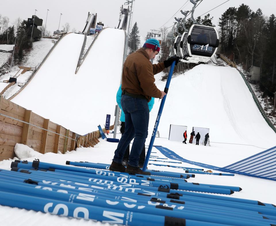 Kai Fischer installs a fence at the bottom of the ski jump at the Olympic Jumping Complex in Lake Placid Jan. 9, 2023. The FISU World University Games will begin this weekend in Lake Placid.