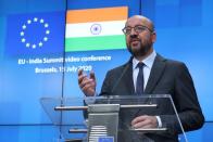 European Council President Charles Michel, Ursula von der Leyen and Indian Prime Minister Narendra Modi are seen on the monitor as they take part in a virtual summit, in Brussels