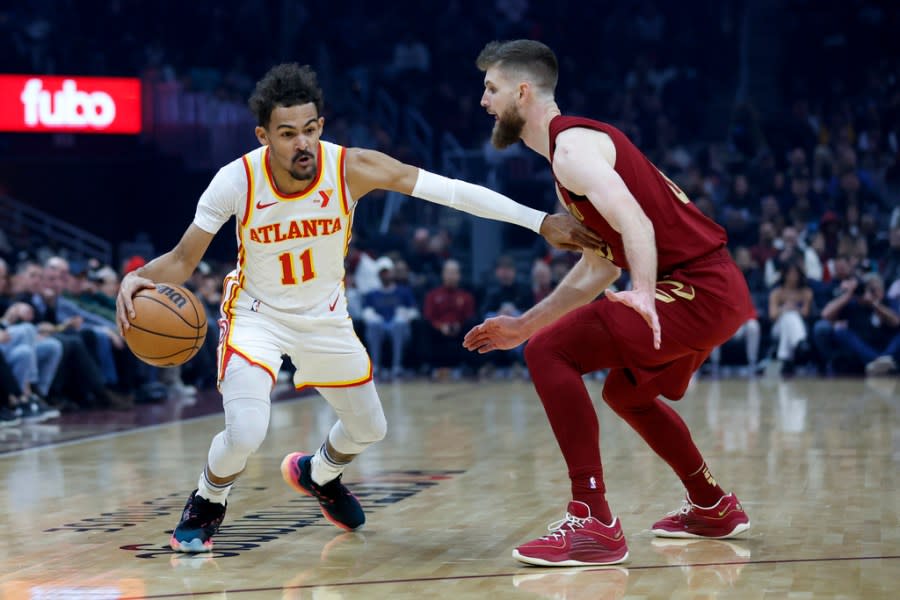 Atlanta Hawks guard Trae Young (11) drives against Cleveland Cavaliers forward Dean Wade during the first half of an NBA basketball game Saturday, Dec. 16, 2023, in Cleveland. (AP Photo/Ron Schwane)