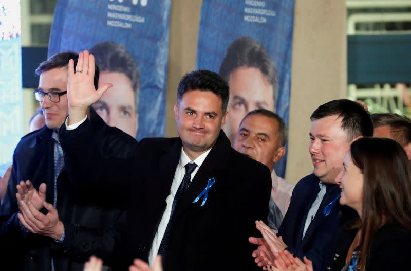 FILE PHOTO: Opposition candidate for prime minister Peter Marki-Zay, next to Budapest's Mayor Gergely Karacsony, waves at the election headquarters in Budapest