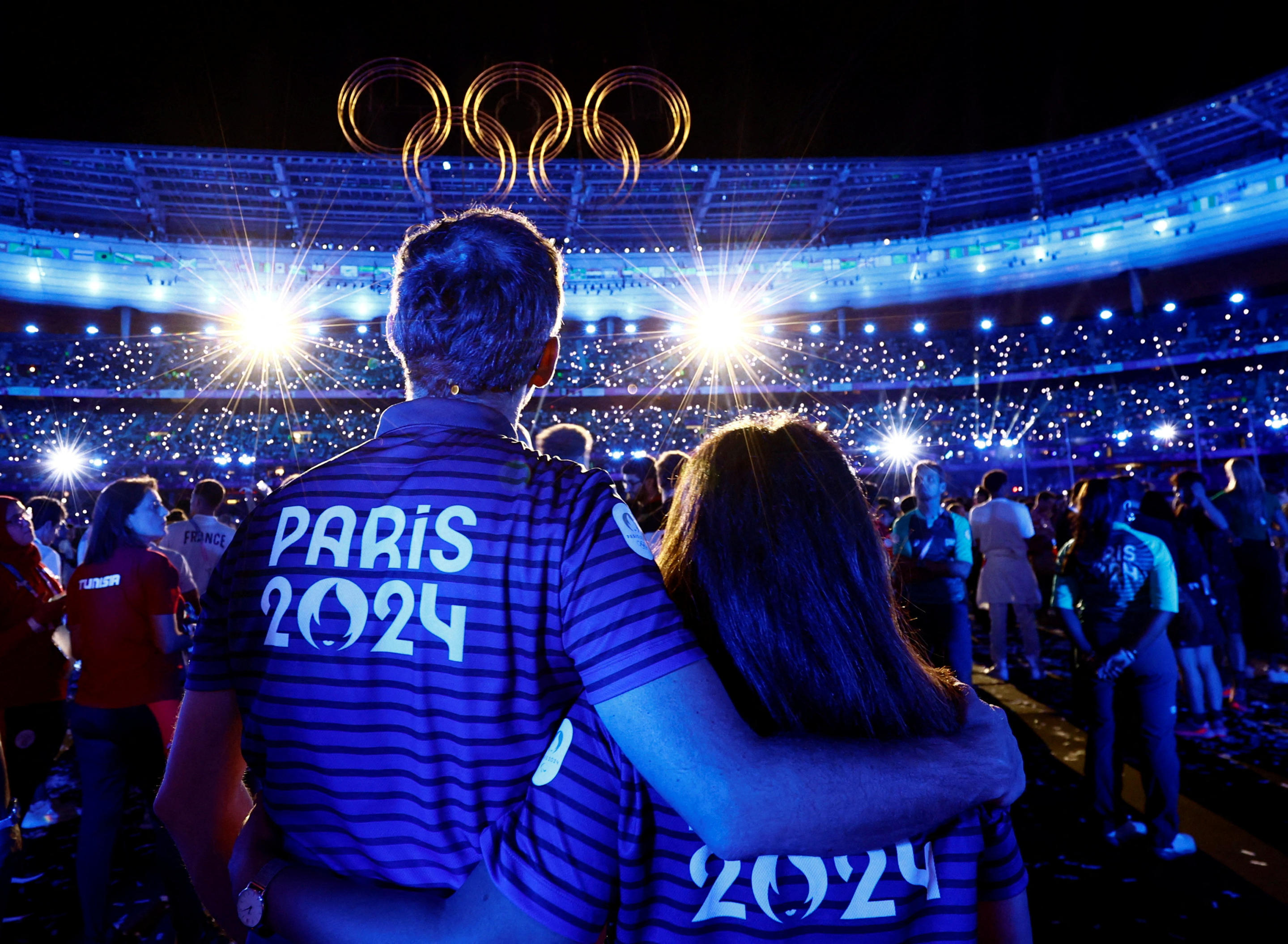 Athletes are flanked by Olympic rings during the closing ceremony. 