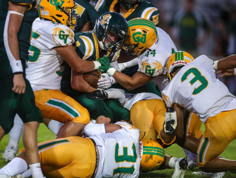 Coachella Valley's Sebastian Arriaga (55), Javi Oliva (31), Isaiah Martinez (44) and Ernesto Recio (3) get in on the action together to bring down Palo Verde's Januel Fernandez (7) during the first quarter of their game at Palo Verde High School in Blythe, Calif., Friday, Aug. 25, 2023.