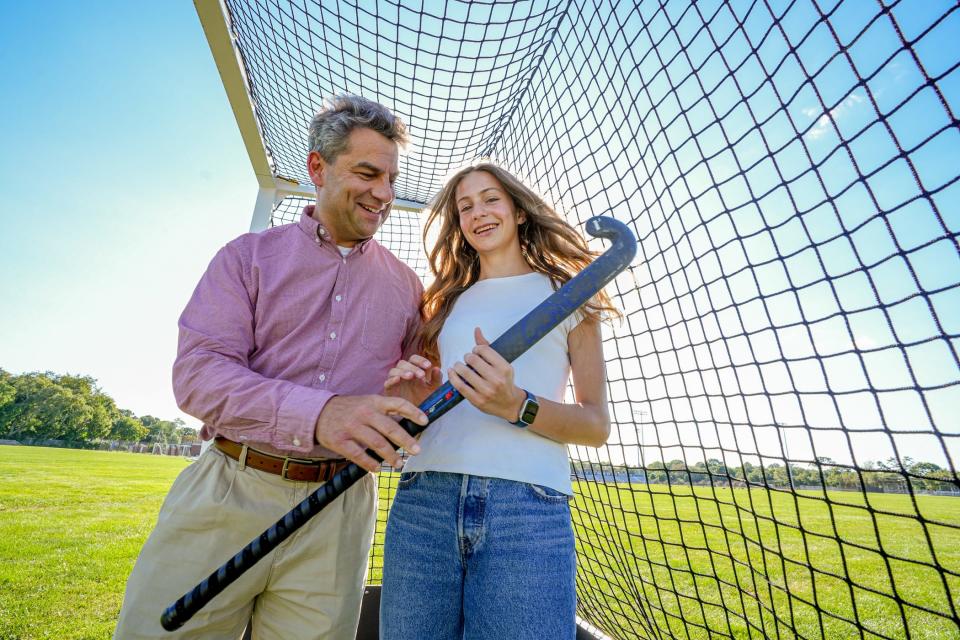 Emma Mueller and her father, Marian Mueller on Barrington High School field hockey practice field. Emma learned the game from her father, who played it in Europe and was also a member of the USA Masters Division team.