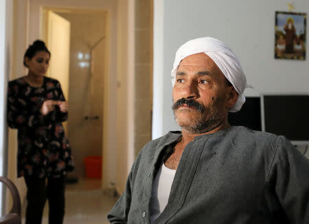 Karam Nassif, an Egyptian Christian, who fled his home in Arish, sits with his family in a rented apartment on the edge of Suez Canal in Ismailia, Egypt, April 24, 2017. Picture taken April 24, 2017. REUTERS/Mohamed Abd El Ghany